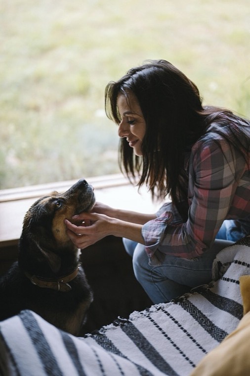 A woman with a dog at home